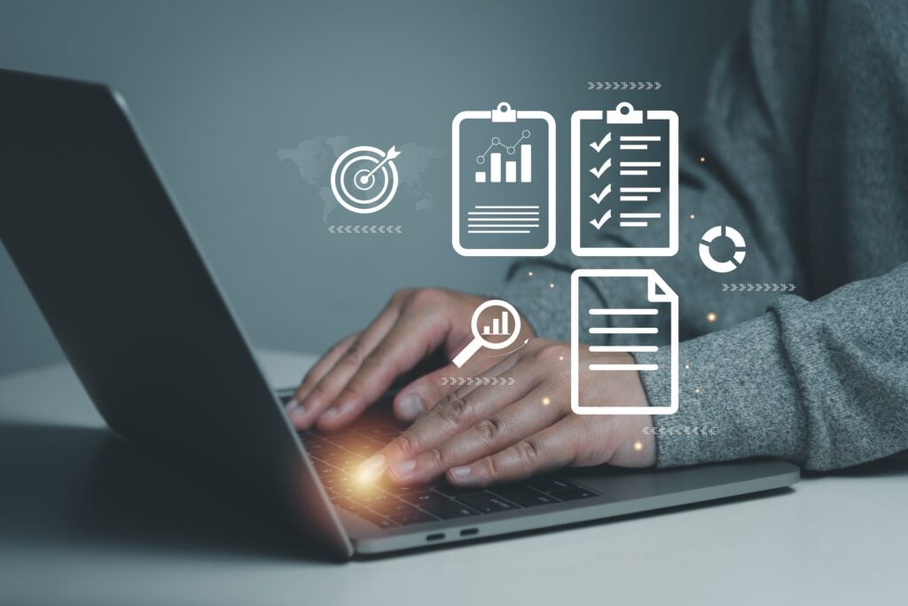 A Shartru Wealth professional works on a laptop with a graphic of business icons.