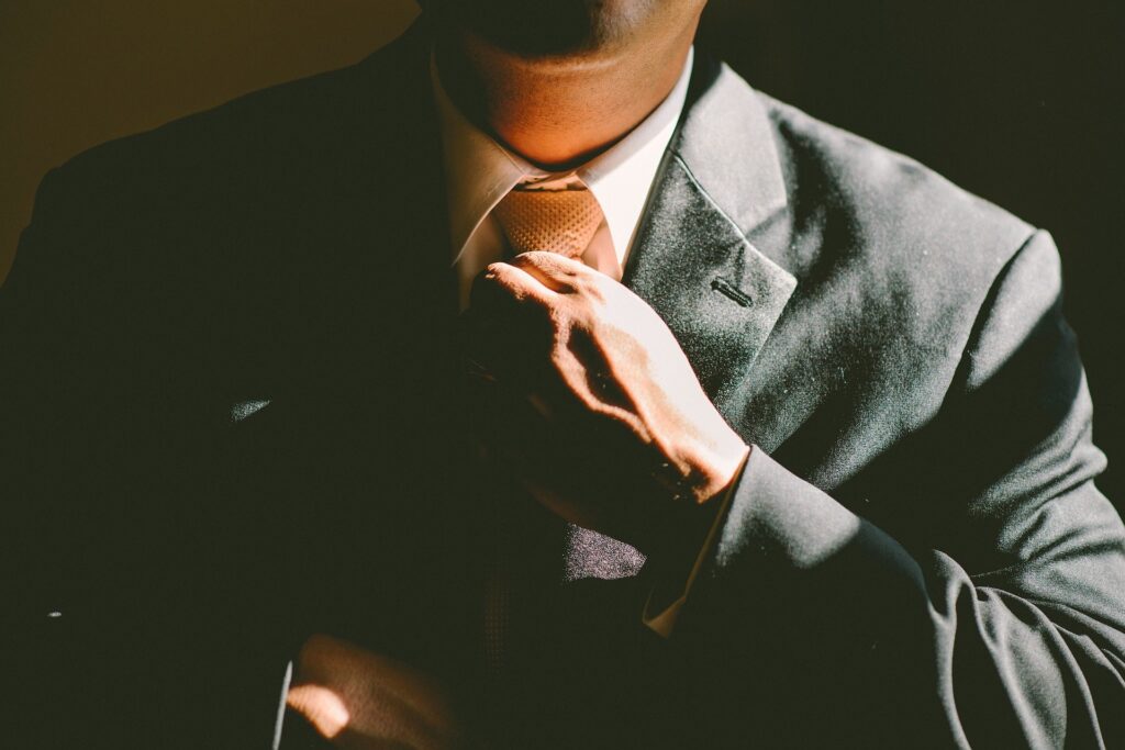 Man adjusting his necktie