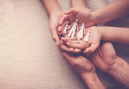 Shartru Wealth image of hands holding paper cutout family representing family trust.