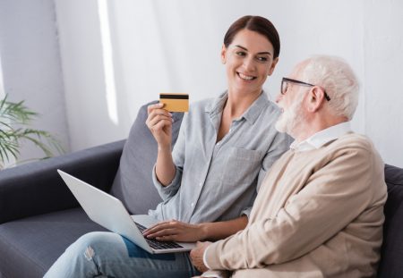 A close-up from Shartru Wealth shows a person's hands pulling out a wallet.