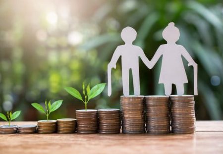 Shartru Wealth Management concept of retirement savings with coins, plants, and elderly couple cutout.