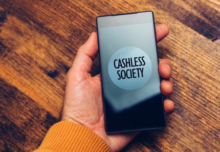 Shartru Wealth image of a smartphone screen displaying the words cashless society.