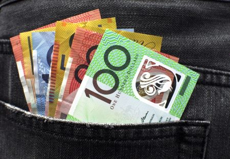 Australian banknotes in a jeans pocket representing junk insurance refunds explained by Shartru Wealth.