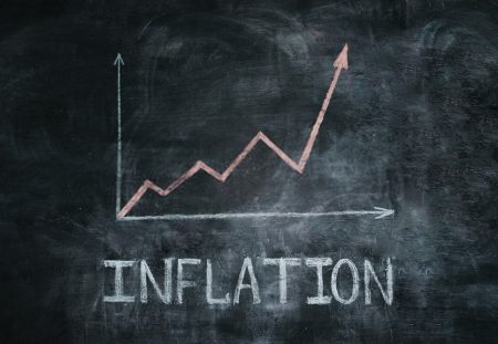 Shartru Wealth chalkboard drawing showing rising inflation graph with upward arrow.