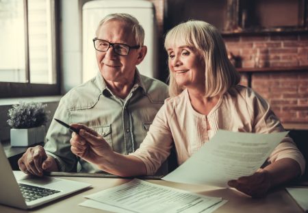 Shartru Wealth retirees comparing documents online about SMSF individual trustee and corporate trustee options.