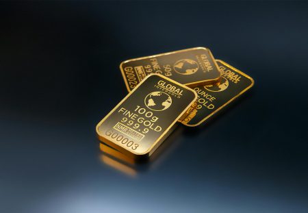Shartru Wealth close-up of gold bullion bars marked 100g fine gold.